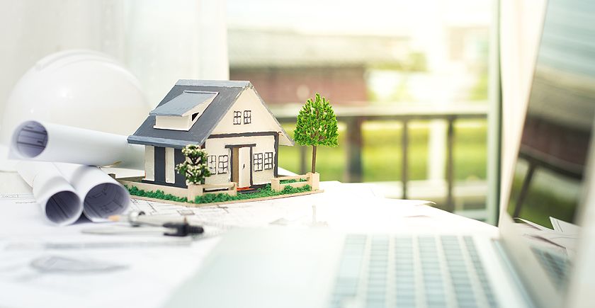 A toy house sitting on top of a table.