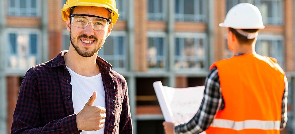 A man in hard hat giving the thumbs up.