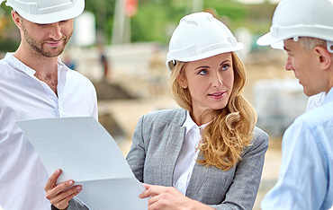 A woman in a white hat and jacket holding papers.