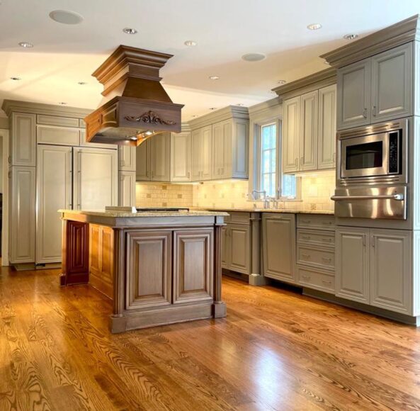 A kitchen with wooden floors and cabinets