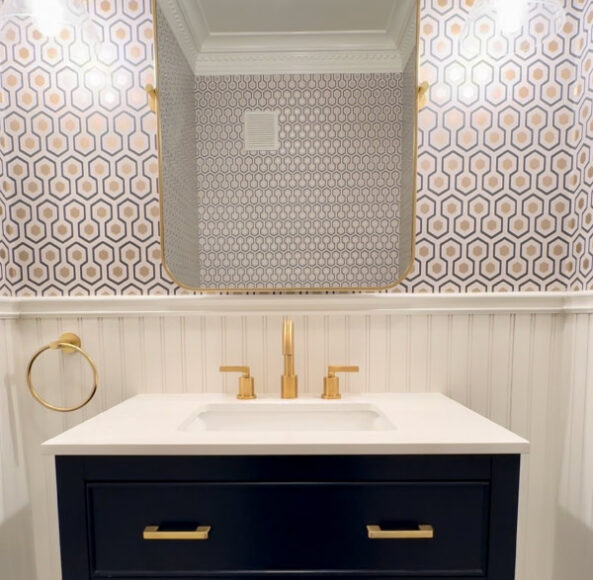 A bathroom with a sink and mirror in it