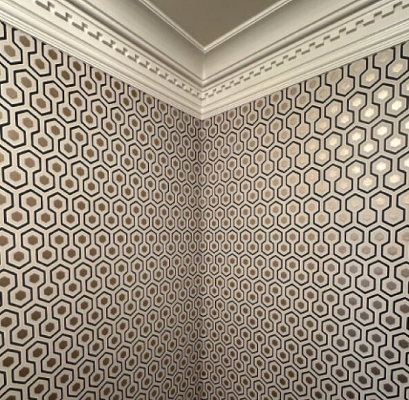 A room with a wall that has many different patterns on it.